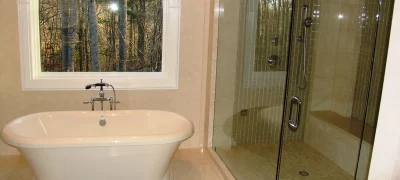 Modern bathroom remodel in Smyrna, GA with soaking tub, walk-in shower, and large window letting in natural light.
