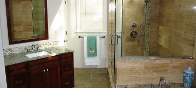 Bathroom remodel in Vinings, GA with spacious walk-in shower, rainfall showerhead, and single-sink vanity by Custom Professional Remodeling.